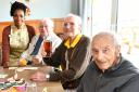 Cheers! Dominoes, cards, and a pint are all in order at the monthly Down Hall pub club