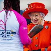 Queen Elizabeth II talks to the first baton bearer, British parasport athlete Kadeena Cox, at the launch of the Queen's Baton Relay for Birmingham 2022.