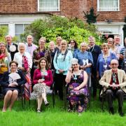 Volunteers and staff, including CEO Dr Helen Glenister (front left), at the Isabel Hospice tea party held at Homestead Court in Welwyn Garden City