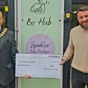 Mayor Frank Marsh and Adam Bracher with his donation to Sparks.