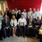 Mayor Cllr Frank Marsh with Matthew Cooper (seated centre) and staff at Woodhouse along with Donna Schultz, CEO of Herts Chamber and Perry Jackson, managing director of Oventrop UK Ltd, award sponsors