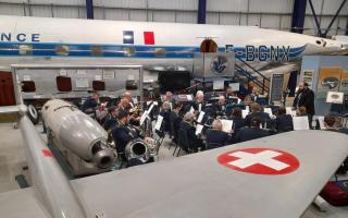The Welwyn Garden City Band performing with the backdrop of the de Havilland Comet Jetliner