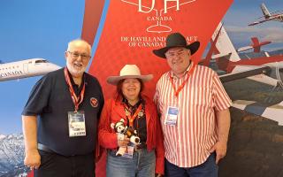 (L-R) Garry Lakin, Sherry Brydson holding Geoffrey Bear and Rob McDonald. Sherry and Rob wear Stetson hats as the Calgary Stampede was underway in Canada