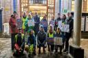 Matt Turmaine MP, centre front row, awaits the start of the march outside Watford Metropolitan Line Underground Station