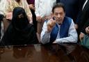 Imran Khan and his wife Bushra Bibi speaking to the media at an office of Lahore High Court in Lahore, Pakistan, in 2023 (KM Chaudary/AP)