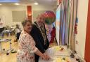 Valerie Skottowe and Mayor Frank Marsh cutting the anniversary cake