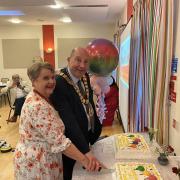 Valerie Skottowe and Mayor Frank Marsh cutting the anniversary cake