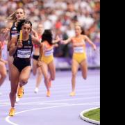 Jodie Williams takes hold of the baton in the 4x400m relay at the Paris Olympics. Picture: MARTIN RICKETT/PA